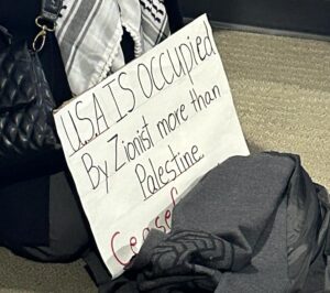 A noxious, antisemitic sign at the Jan. 23 Council meeting echoed a white supremacist conspiracy theory: “U.S.A. is occupied by Zionist more than Palestine” 